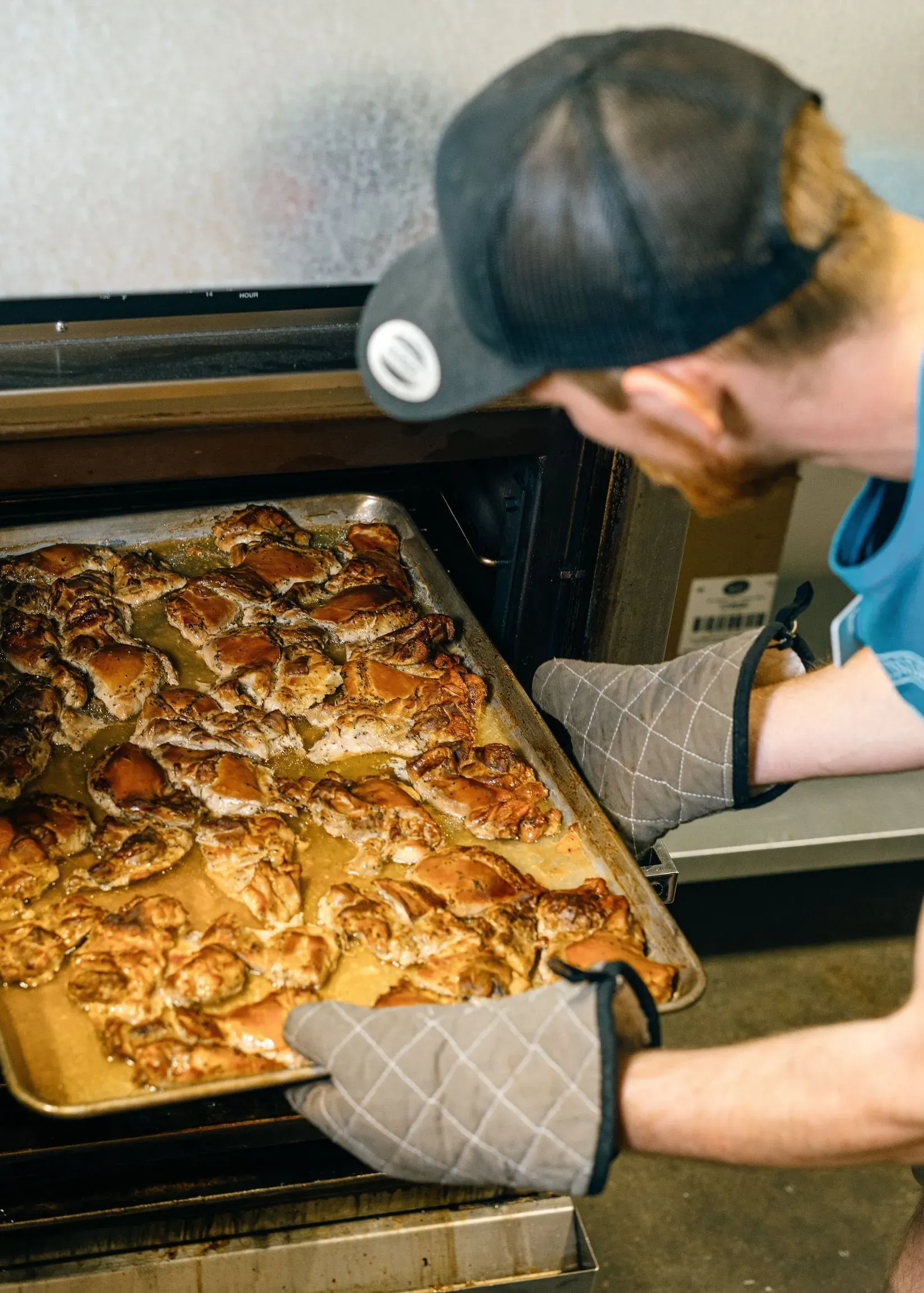 Person putting food in the oven at Dirty Laundry Winery