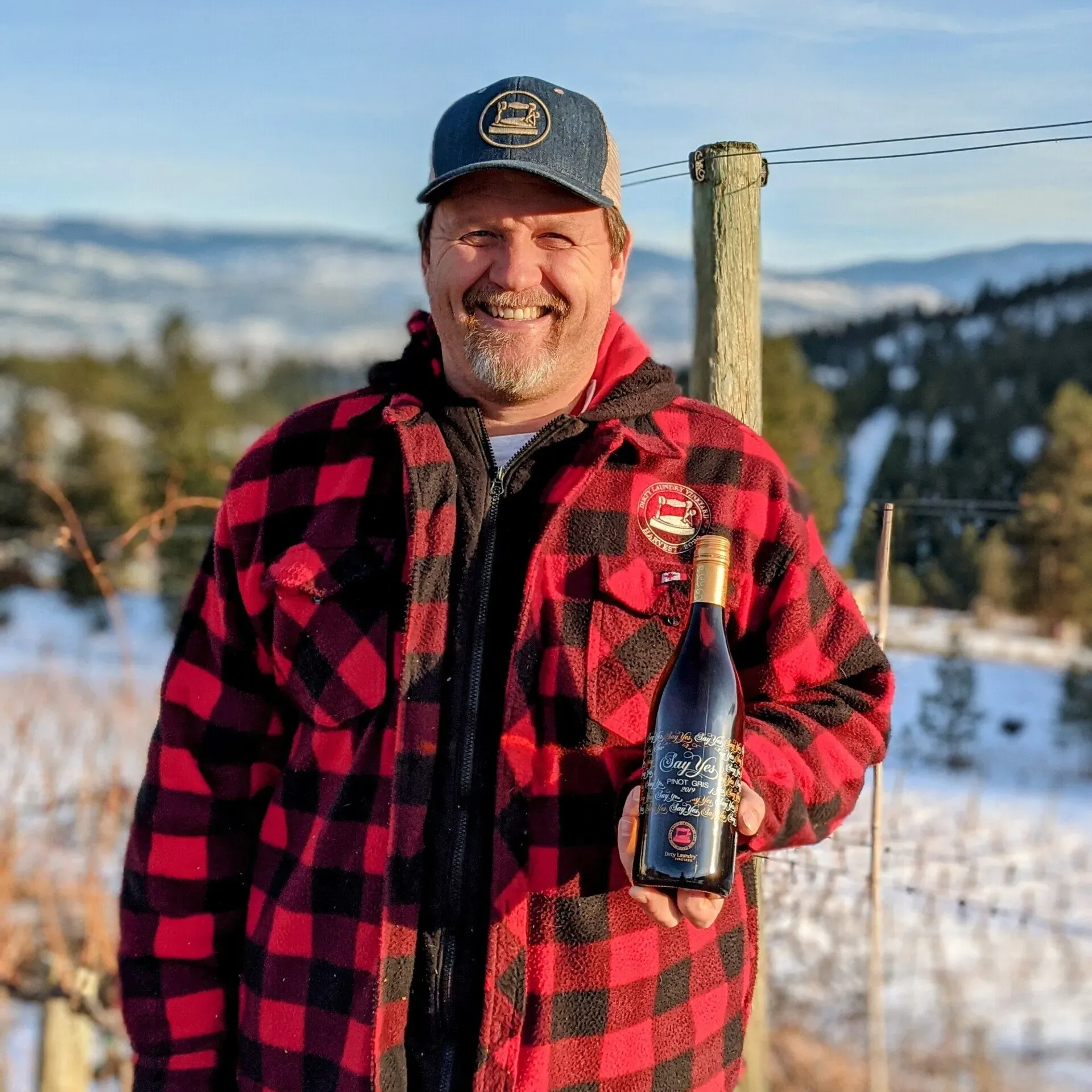 Chris holding a bottle of Dirty Laundry Wine