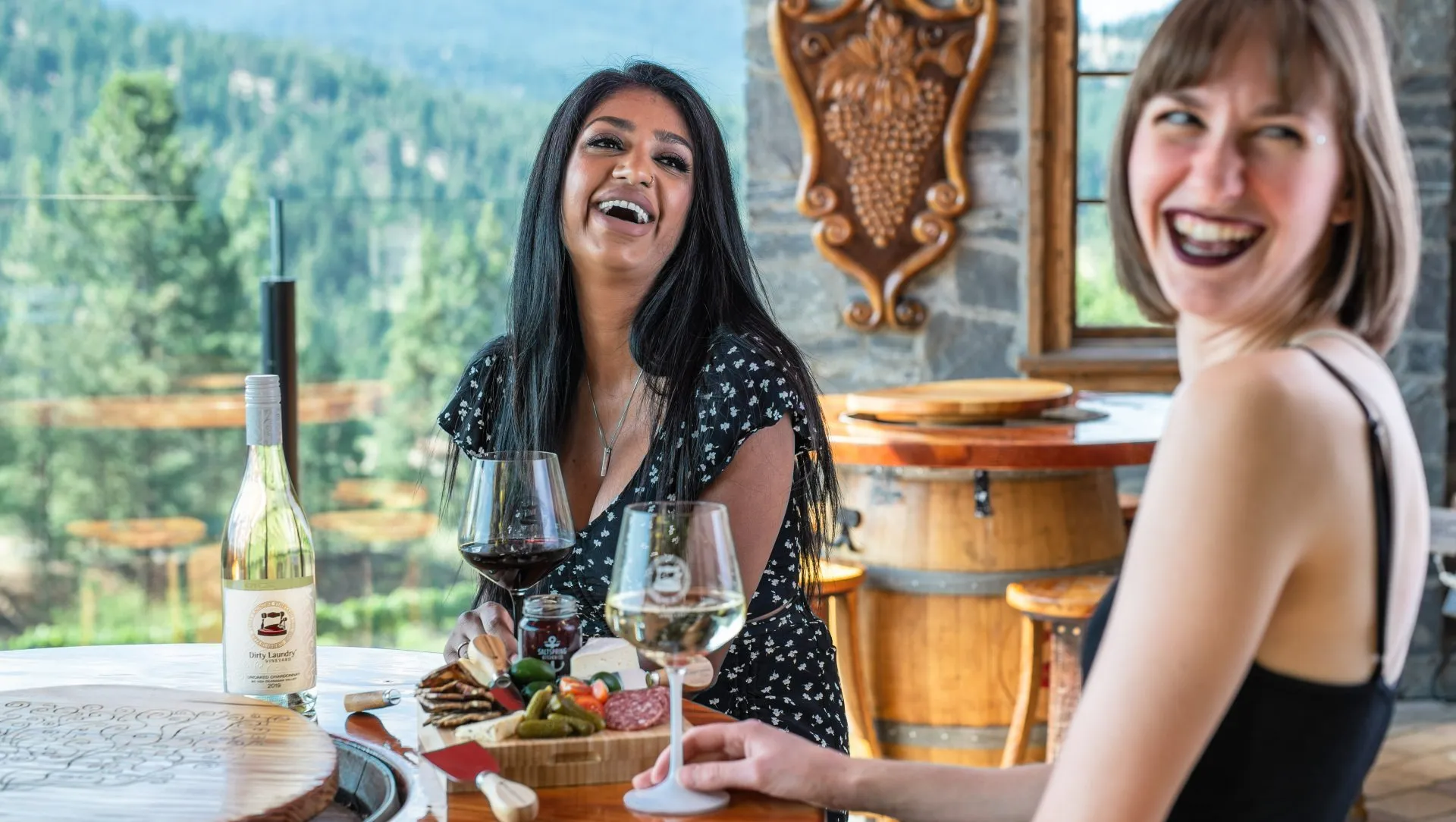 Two women enjoying wine at Dirty Laundry winery